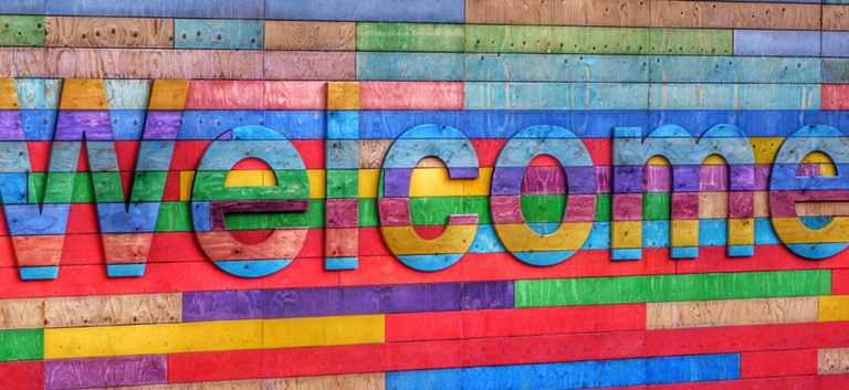 multi-colored wood planks spelling out the word welcome