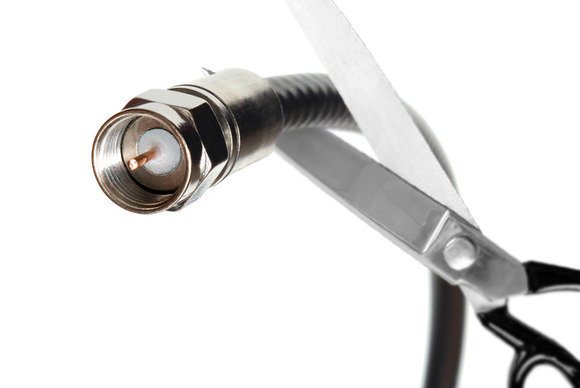 a coax cable being cut with scissors