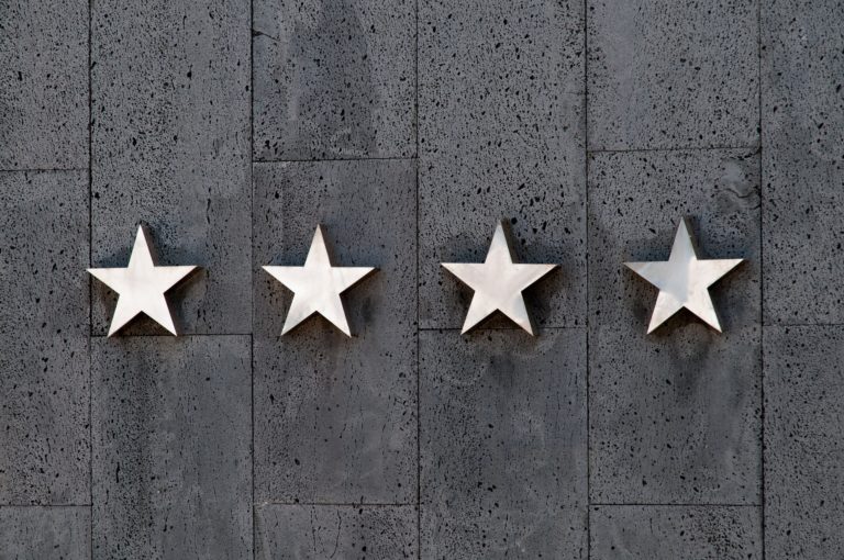 four stars on a gray wall