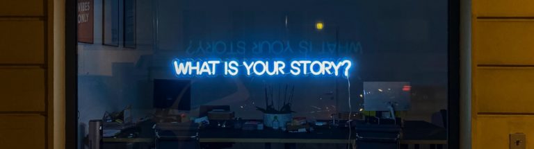 the words what is your story? in neon