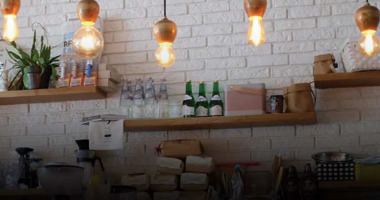 lightbulbs and bottles of water within a coffee shop interior