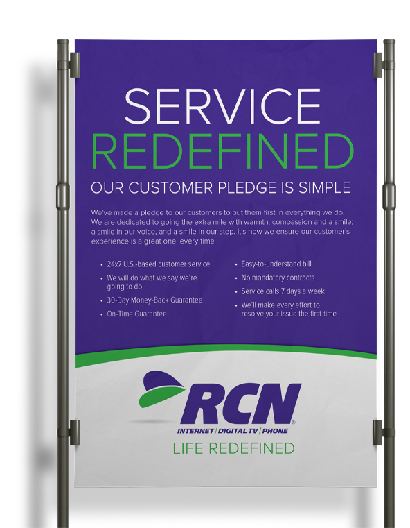a stand up poster with the words service redefined with the new RCN rebranded logo