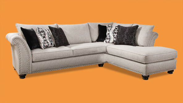 a tan couch with black and white pillows on a orange background for weekends only