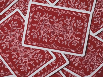 Suite of playing cards on their faces spread out across surface