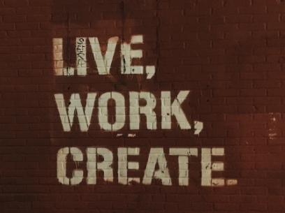 the words Live, Work, Create painted onto brick wall surface
