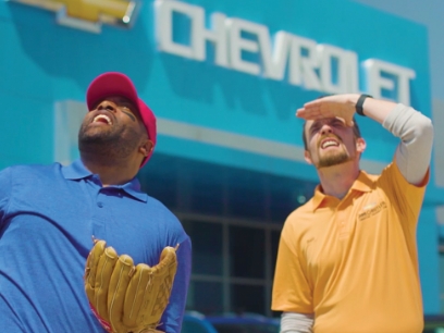 Two actors outside Jim Butler Chevrolet dealership in a still from a commercial shot by Stealth